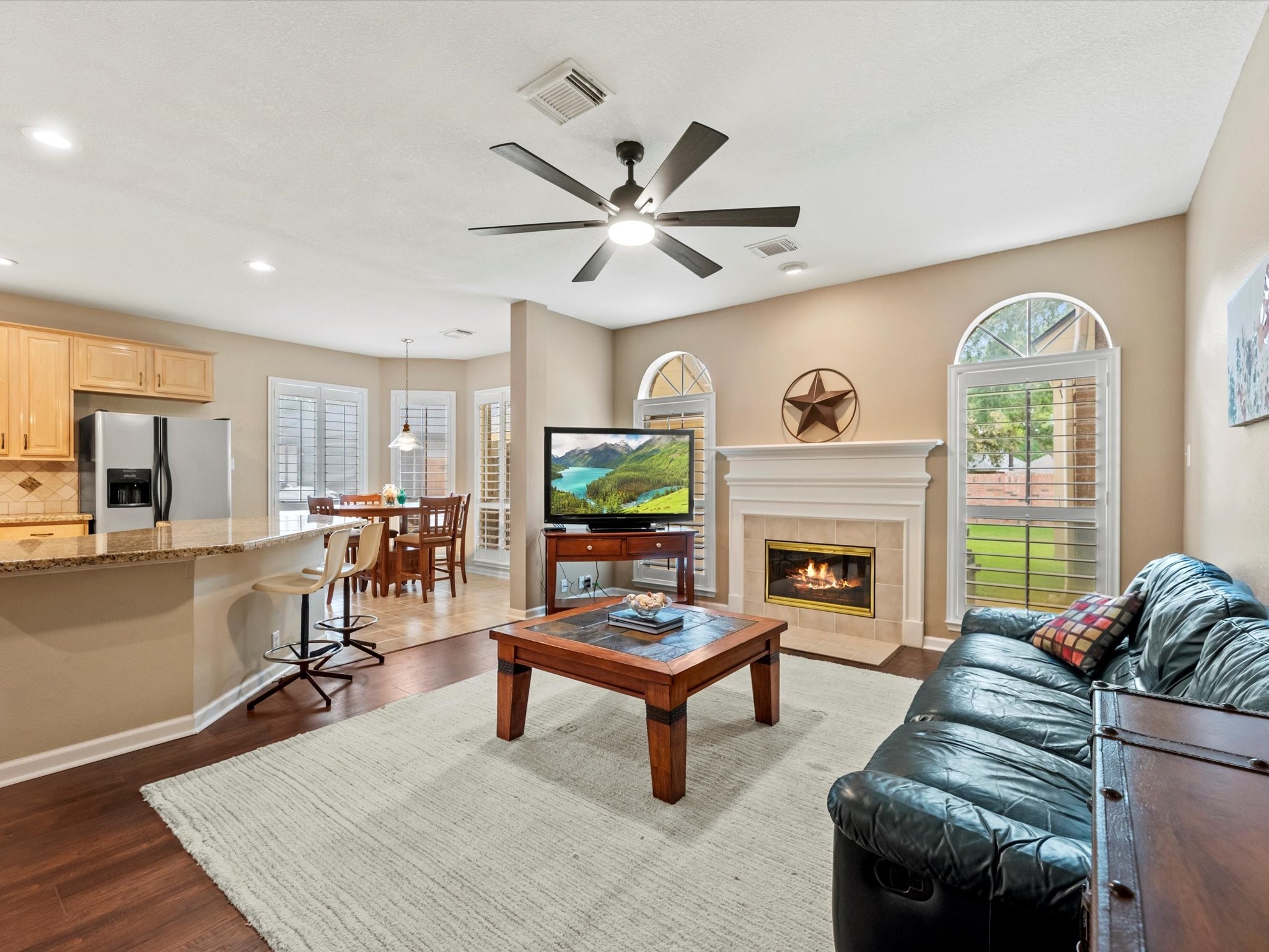 911 Chinni Court Houston, TX 77094 - Photo 11 of 31 a living room with furniture a fireplace and a flat screen tv