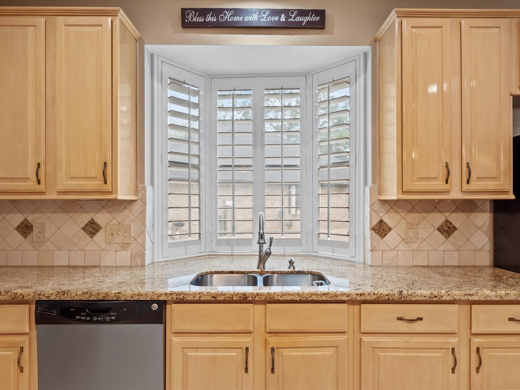 911 Chinni Court Houston, TX 77094 - Photo 16 of 31 a kitchen with granite countertop cabinets sink and window