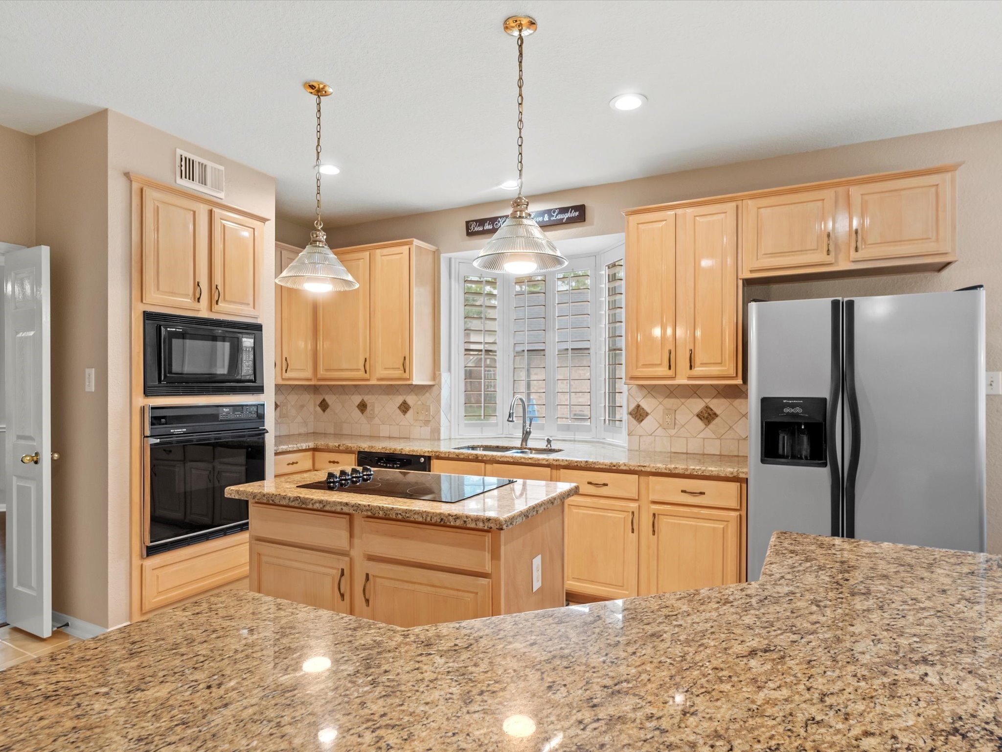 911 Chinni Court Houston, TX 77094 - Photo 17 of 31 a kitchen with stainless steel appliances kitchen island granite countertop a sink stove and refrigerator