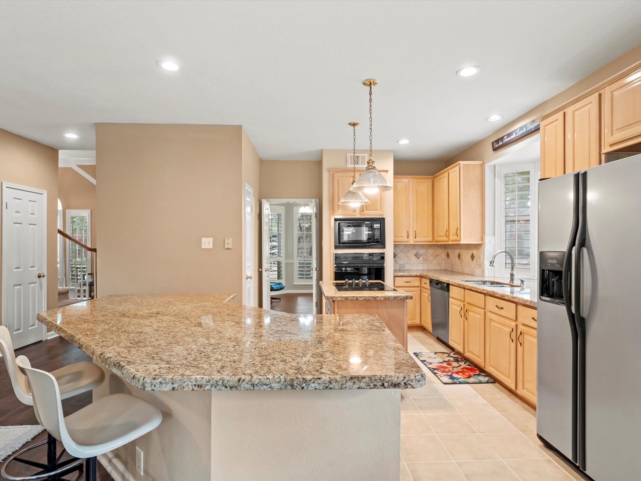 911 Chinni Court Houston, TX 77094 - Photo 18 of 31 a kitchen with stainless steel appliances granite countertop a refrigerator a oven a sink and a granite counter tops