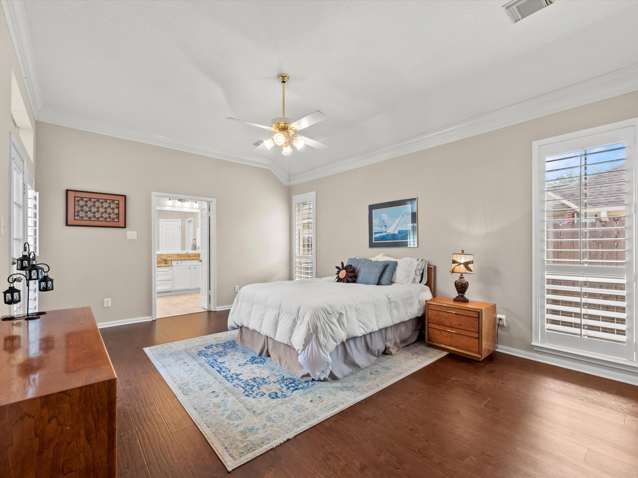 911 Chinni Court Houston, TX 77094 - Photo 19 of 31 a spacious bedroom with a bed dresser and wooden floor