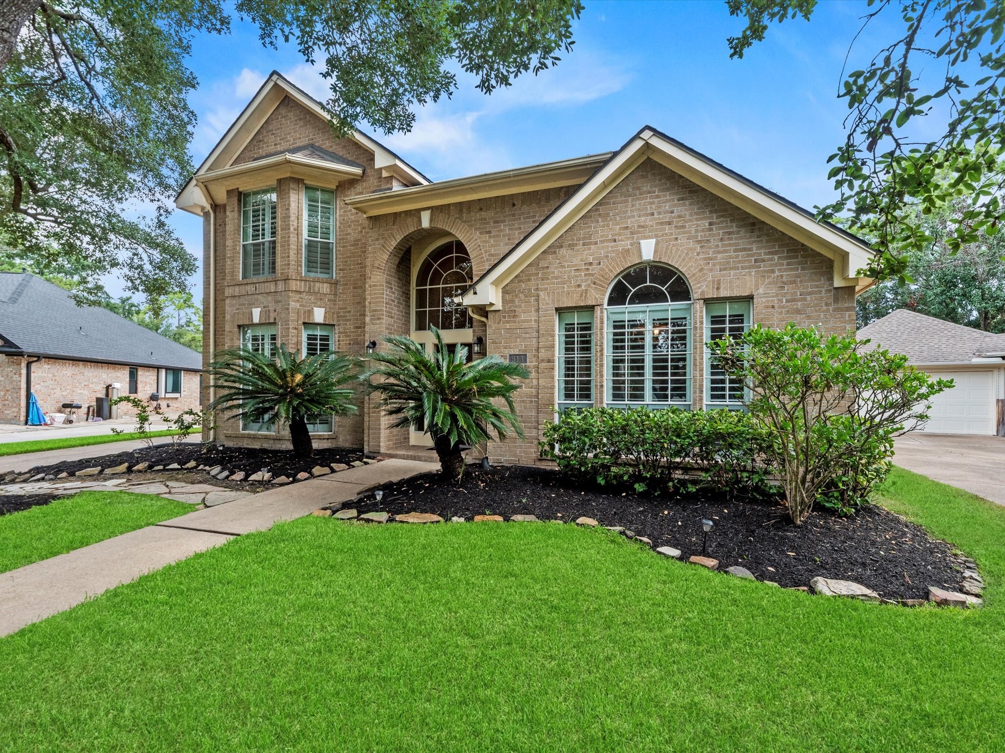 911 Chinni Court Houston, TX 77094 - Photo 2 of 31 a front view of a house with a garden and plants