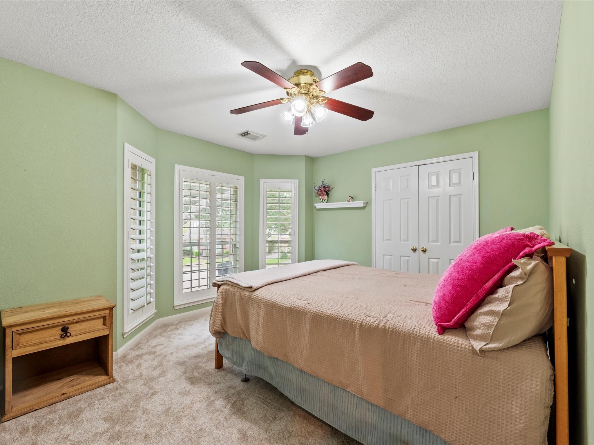 911 Chinni Court Houston, TX 77094 - Photo 25 of 31 a bedroom with a bed and a chandelier