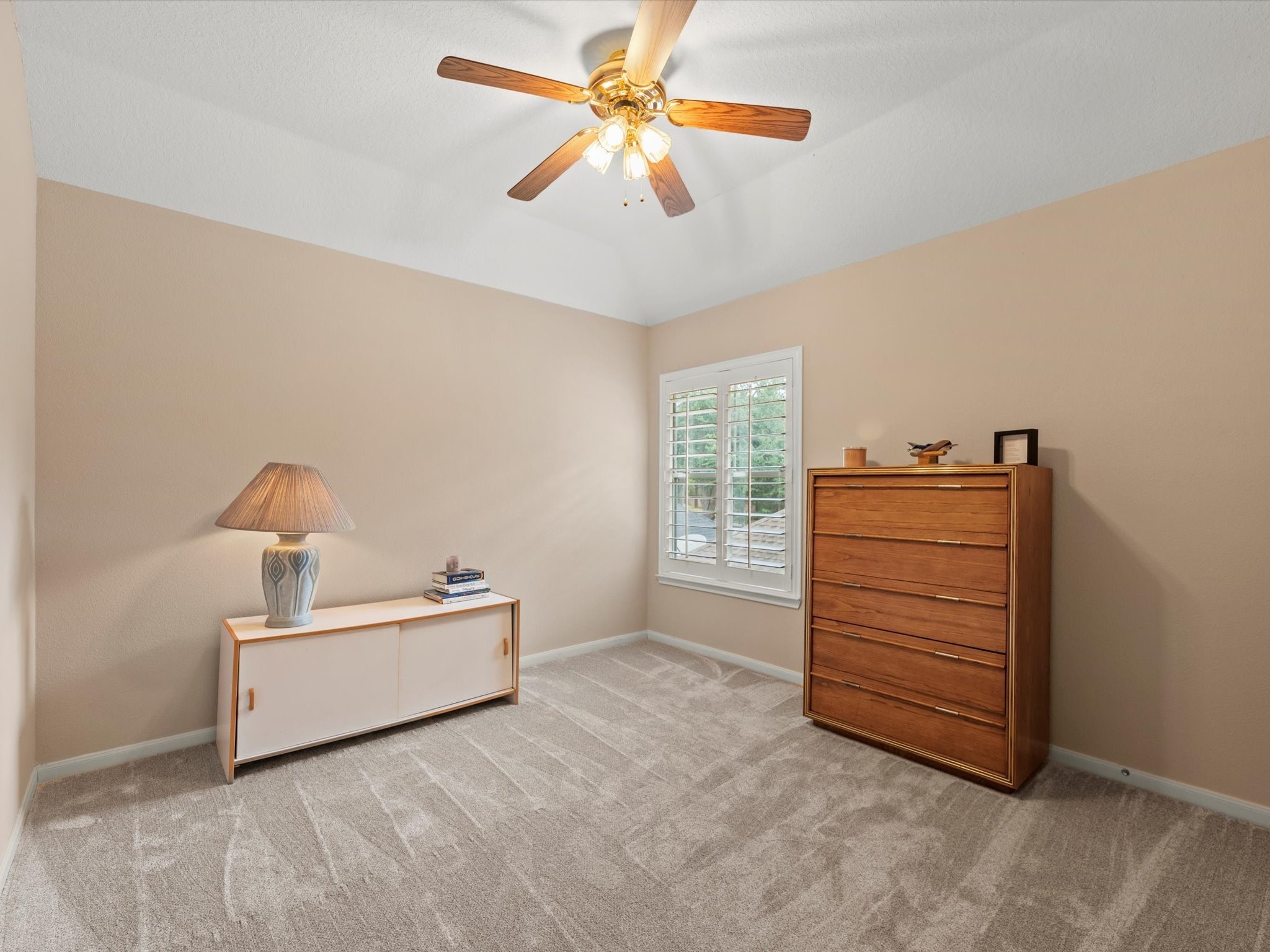 911 Chinni Court Houston, TX 77094 - Photo 27 of 31 a living room with a cabinet and a ceiling fan