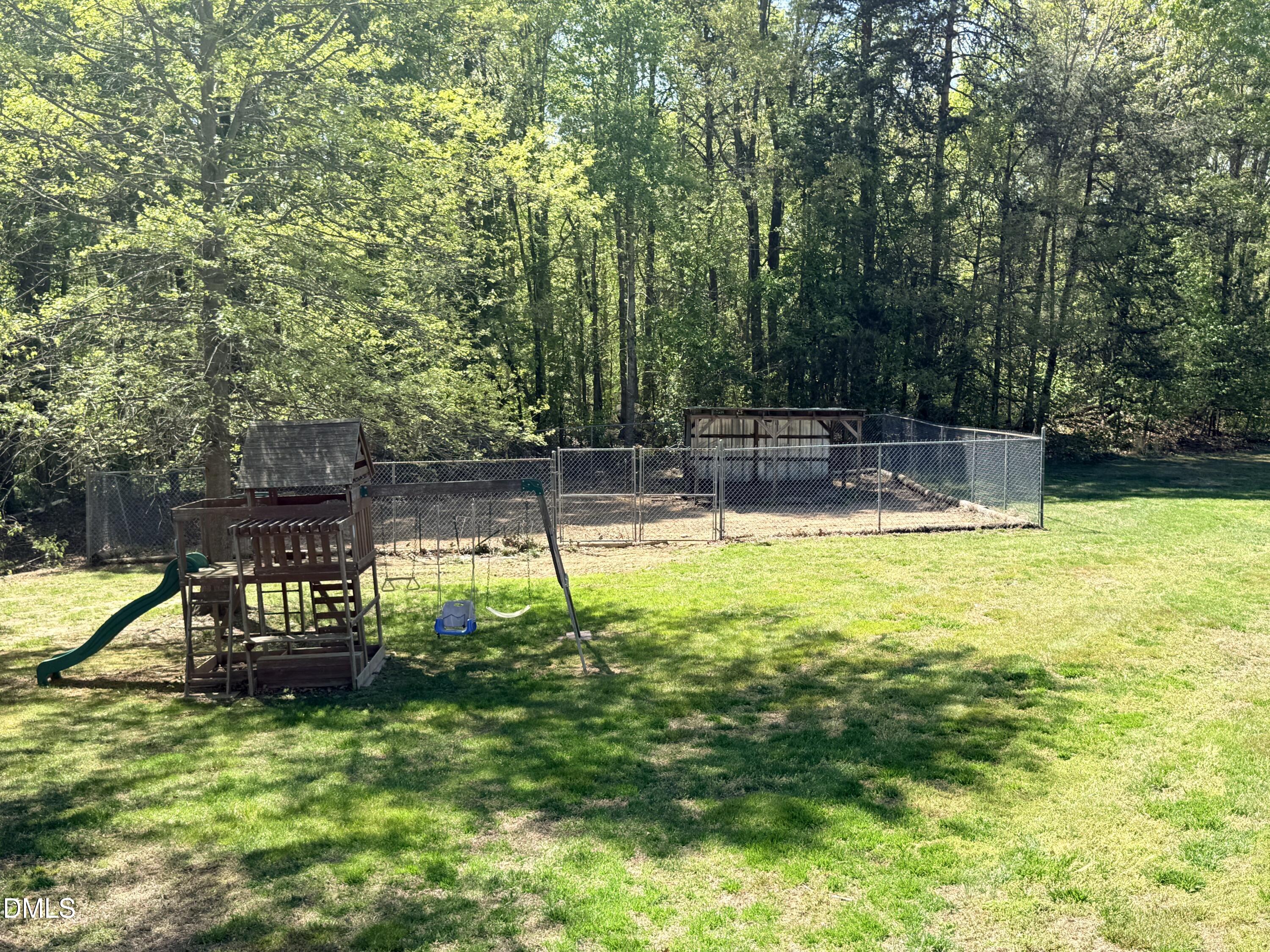 2429 Halifax Road Roxboro, NC 27573 - Photo 51 of 54 a view of a swimming pool with a bench and trees
