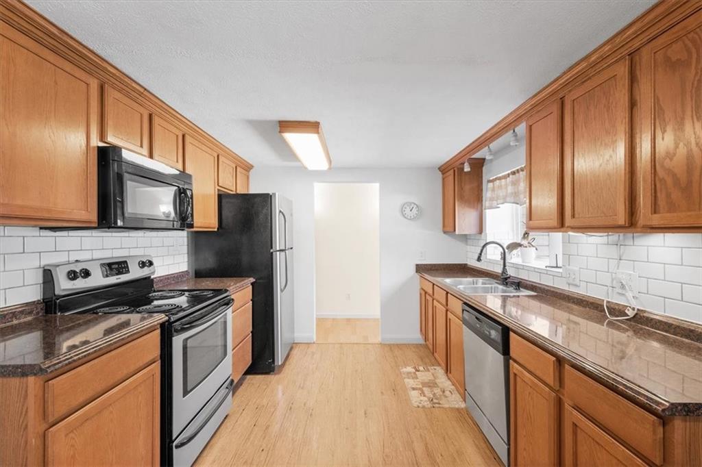 131 Ridgewood Road Coraopolis, PA 15108 - Photo 2 of 39 a kitchen with stainless steel appliances granite countertop a sink stove microwave and refrigerator