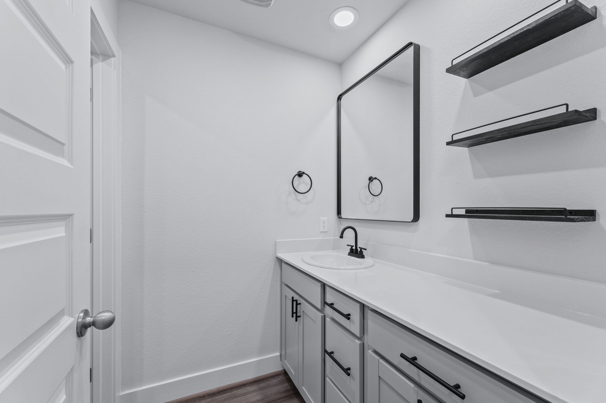 7312 Travertine Spring Drive Austin, TX 78744 - Photo 24 of 32 Modern vanity with clean lines and open shelving for storage.