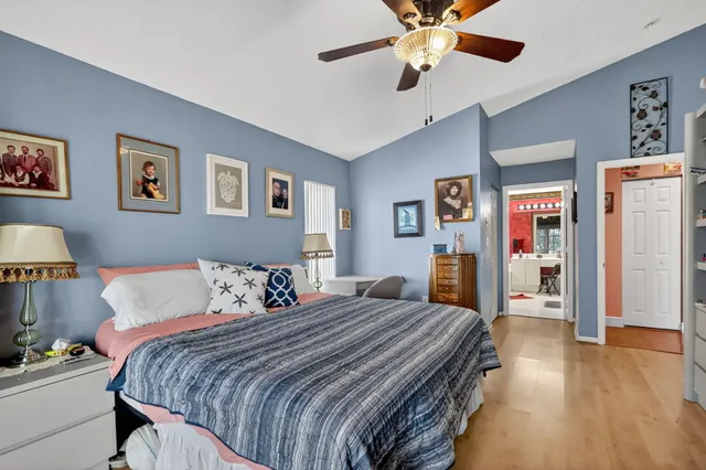 a bedroom with bed and wooden floor