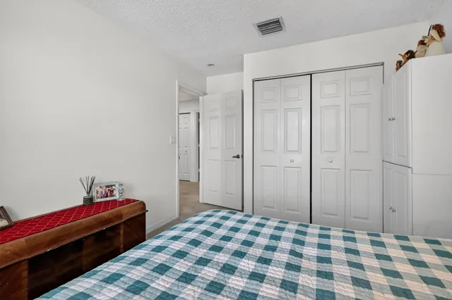 a bedroom with a bed and a mirror