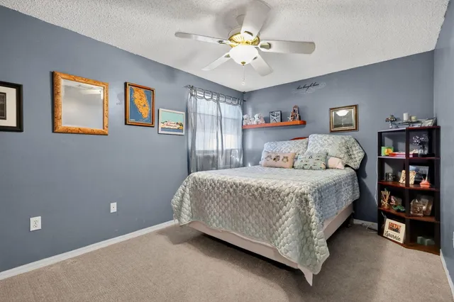 a bedroom with a bed and a book shelf