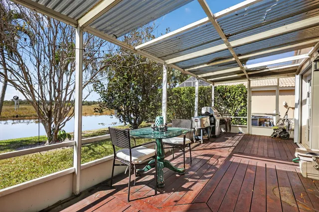 a view of a patio with table and chairs and wooden floor