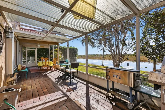 a view of a patio with table and chairs next to a yard