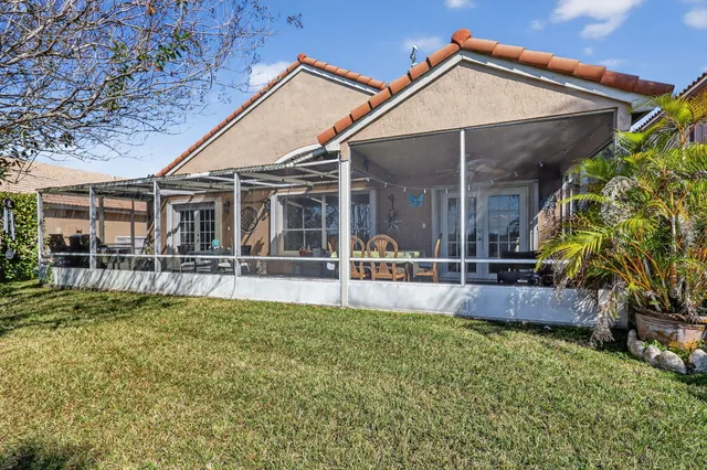 a view of a house with pool and sitting area