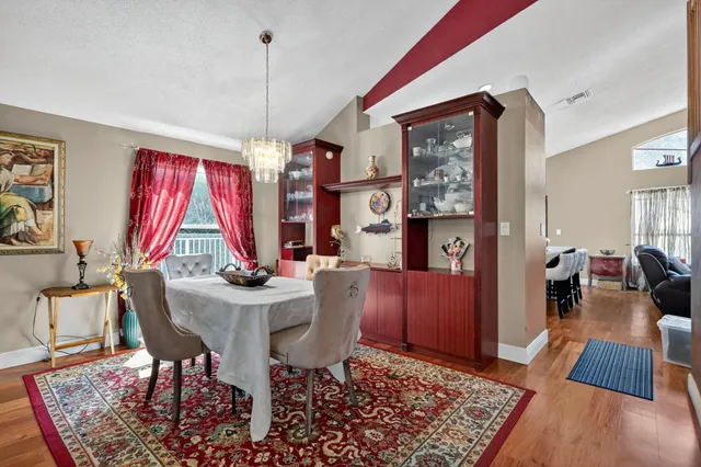 a view of a dining room with furniture window and wooden floor