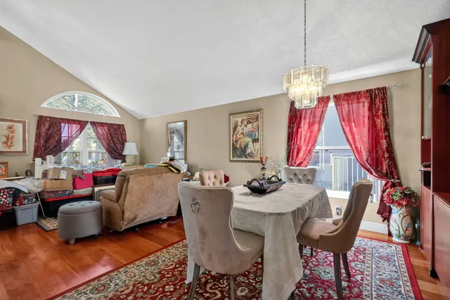 a view of a dining room with furniture wooden floor and a chandelier