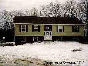 4 J J Road Moscow, PA 18444 - Photo 1 of 1 a front view of a house with a yard covered in snow