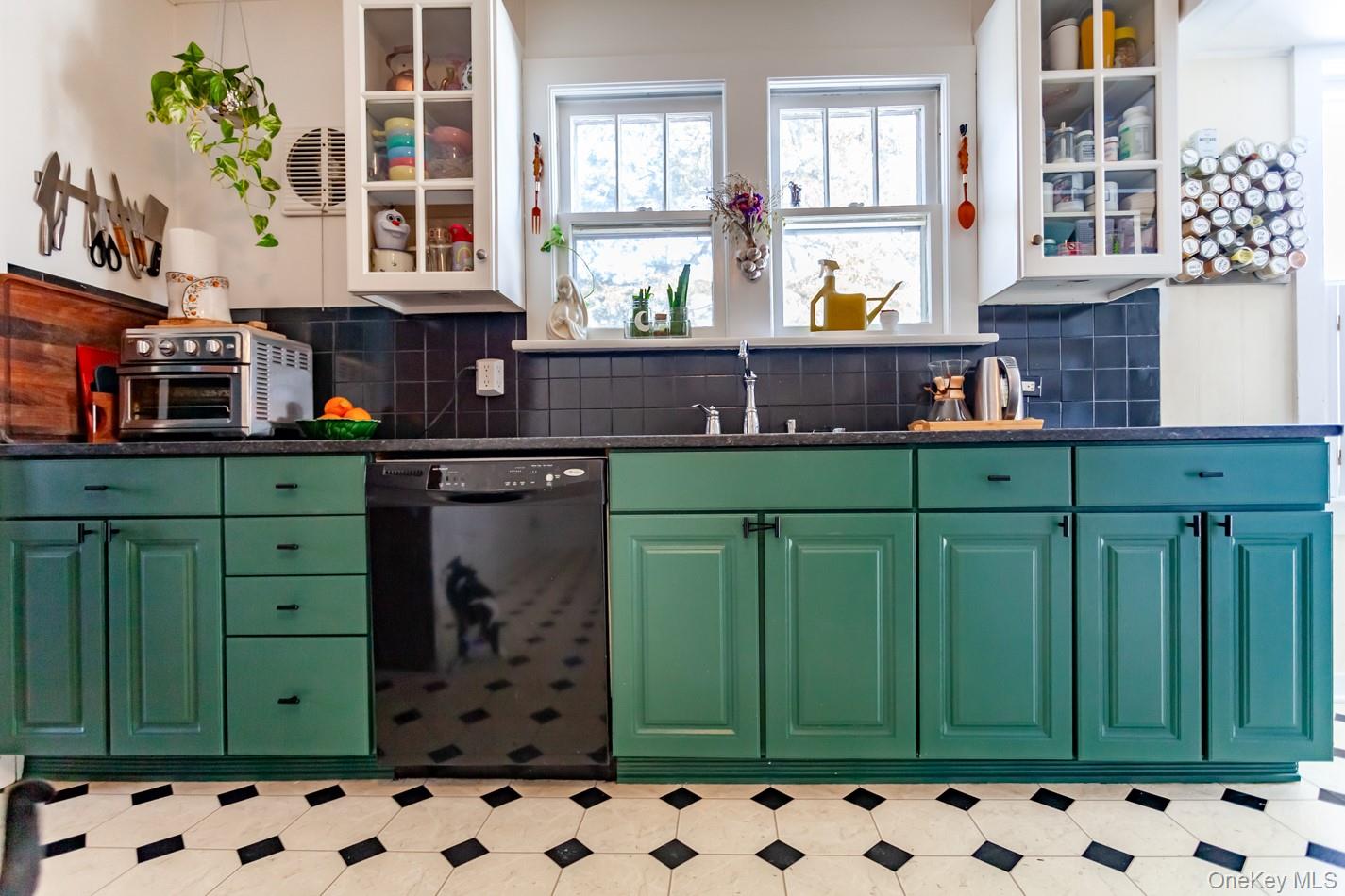 1710 Highway 9D Cold Spring, NY 10516 - Photo 14 of 41 Kitchen with green cabinetry, glass insert cabinets, dishwasher, and light floors