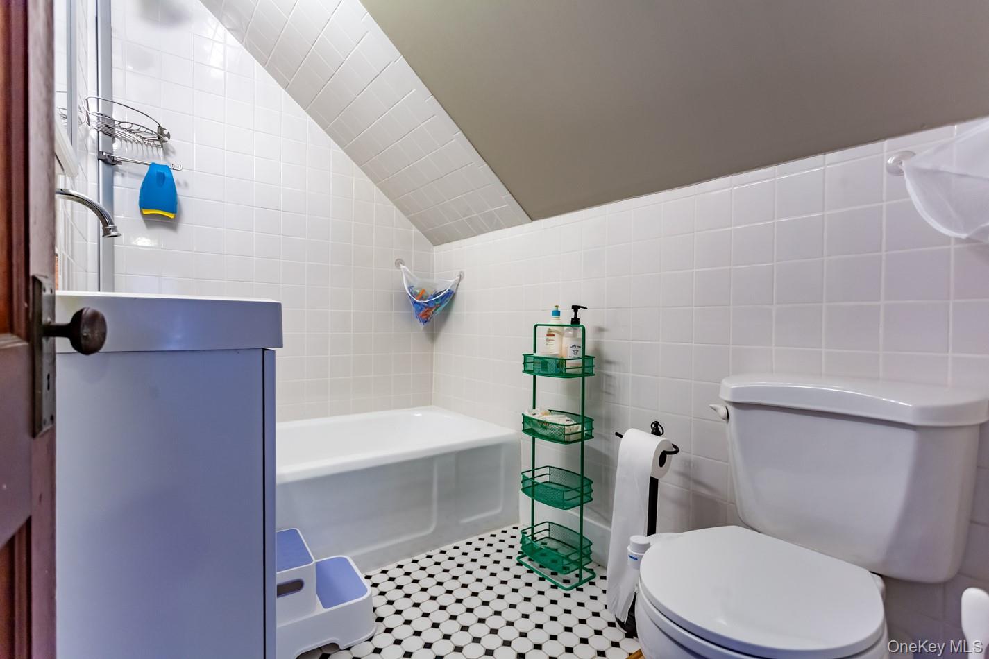 1710 Highway 9D Cold Spring, NY 10516 - Photo 23 of 41 Full bathroom featuring tile walls, lofted ceiling, and light tile patterned floors