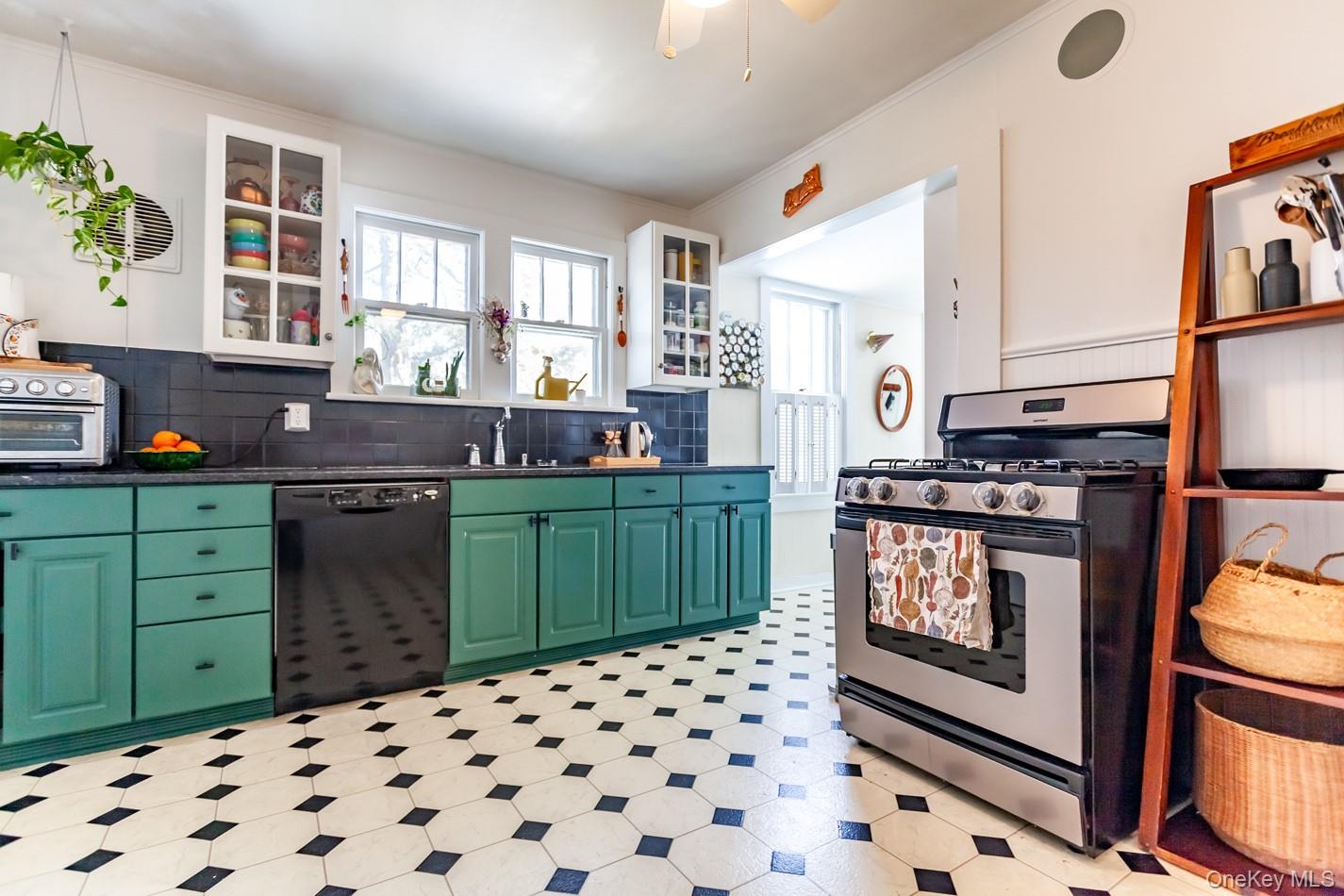 1710 Highway 9D Cold Spring, NY 10516 - Photo 27 of 41 Kitchen with green cabinetry, stainless steel gas range, glass insert cabinets, dishwasher, and light flooring