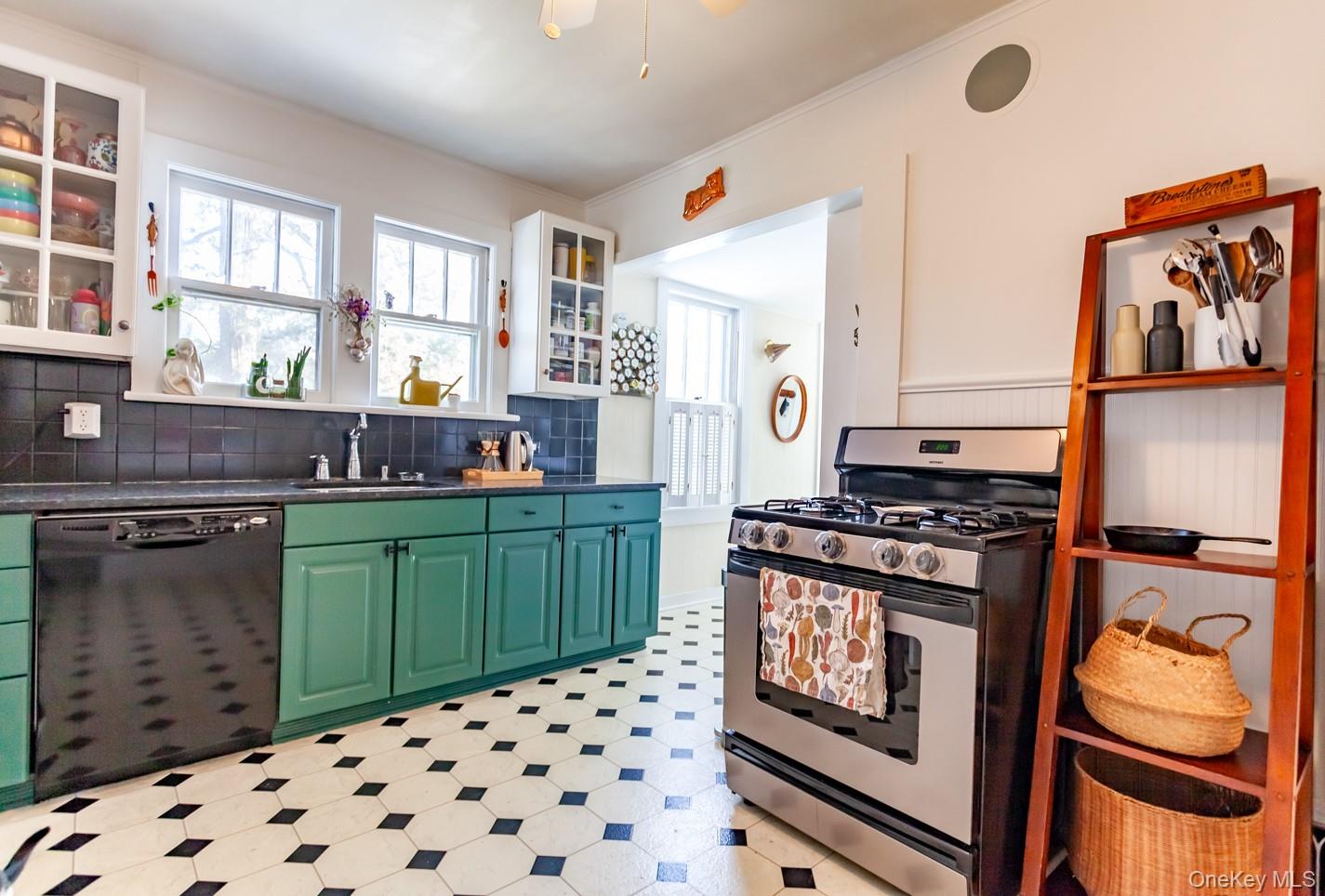 1710 Highway 9D Cold Spring, NY 10516 - Photo 3 of 41 Kitchen with stainless steel gas range, green cabinets, dishwasher, glass insert cabinets, and ornamental molding