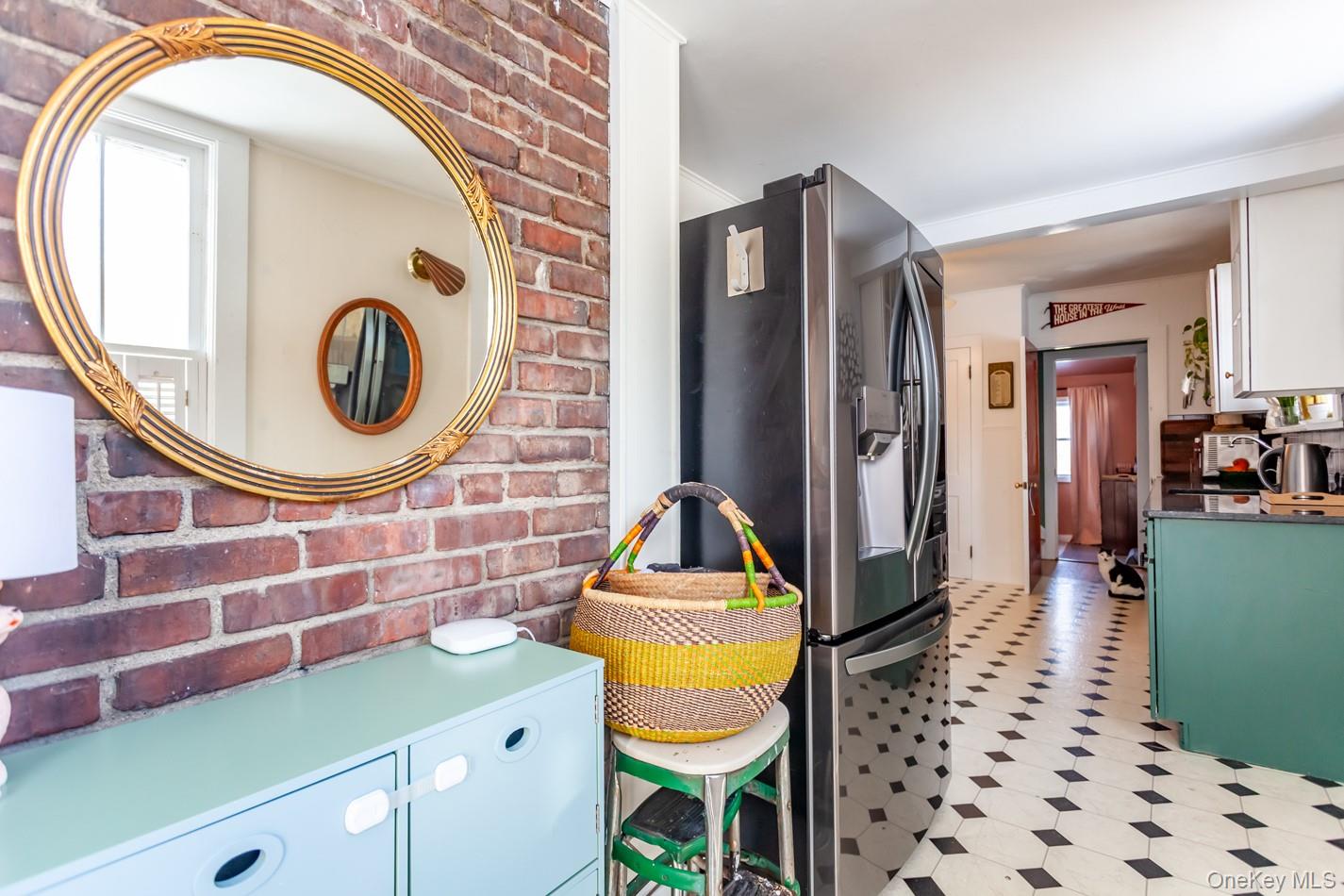 1710 Highway 9D Cold Spring, NY 10516 - Photo 5 of 41 Kitchen with brick wall, stainless steel refrigerator with ice dispenser, light floors, white cabinets, and green cabinetry