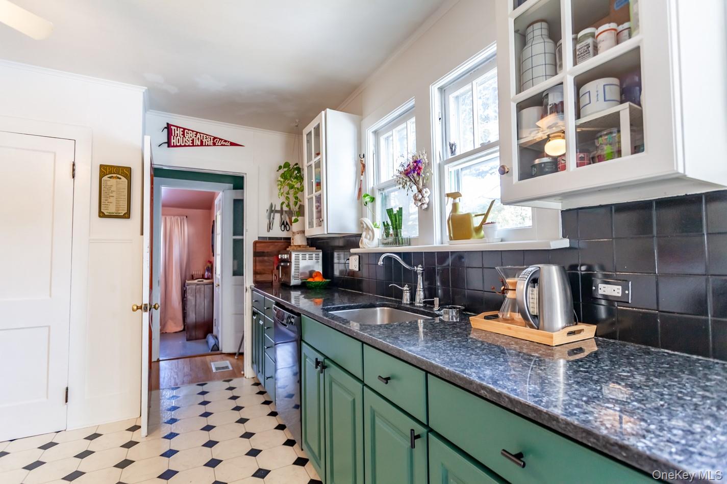 1710 Highway 9D Cold Spring, NY 10516 - Photo 6 of 41 Kitchen featuring glass insert cabinets, green cabinetry, dark stone counters, backsplash, and light floors