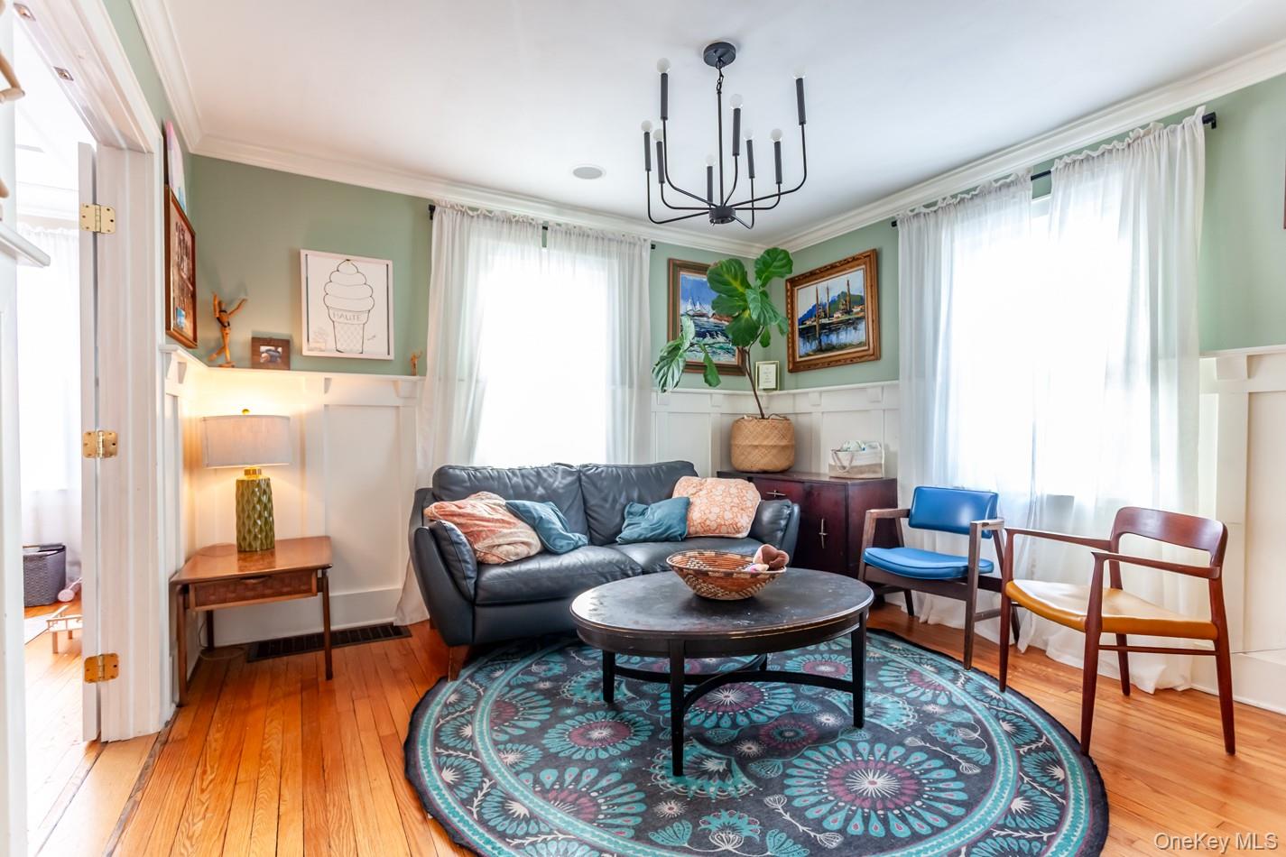 1710 Highway 9D Cold Spring, NY 10516 - Photo 7 of 41 Living area with ornamental molding, light wood-style floors, a chandelier, and a decorative wall
