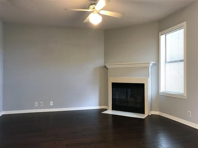 502 West 17th Street, Unit B Austin, TX 78701 - Photo 3 of 3 an empty room with wooden floor fireplace and windows