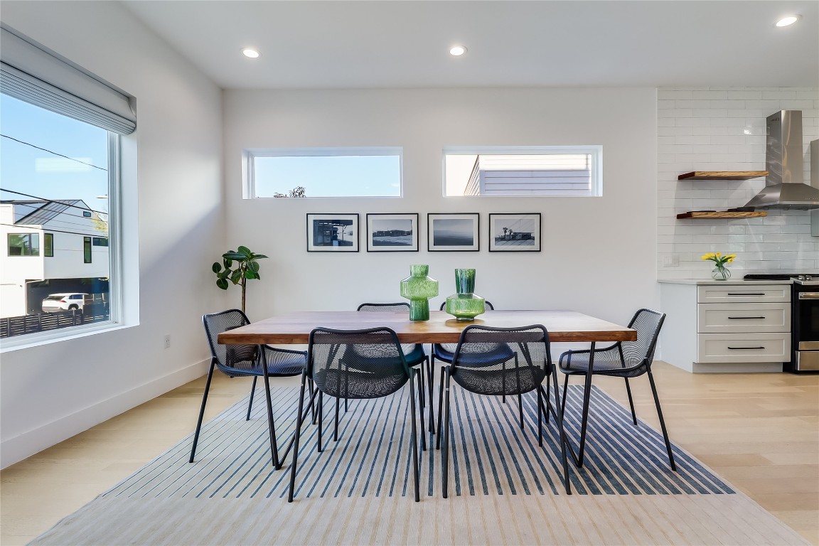 4712 Reyes Street, Unit 1 Austin, TX 78721 - Photo 11 of 40 a view of a dining room with furniture and wooden floor