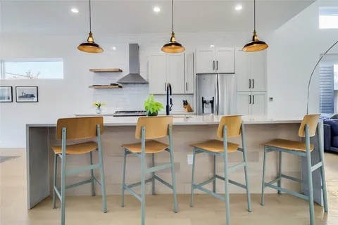 a dining room with furniture and wooden floor