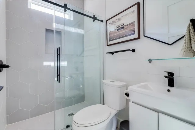 a kitchen with stainless steel appliances kitchen island granite countertop dining table chairs and a sink