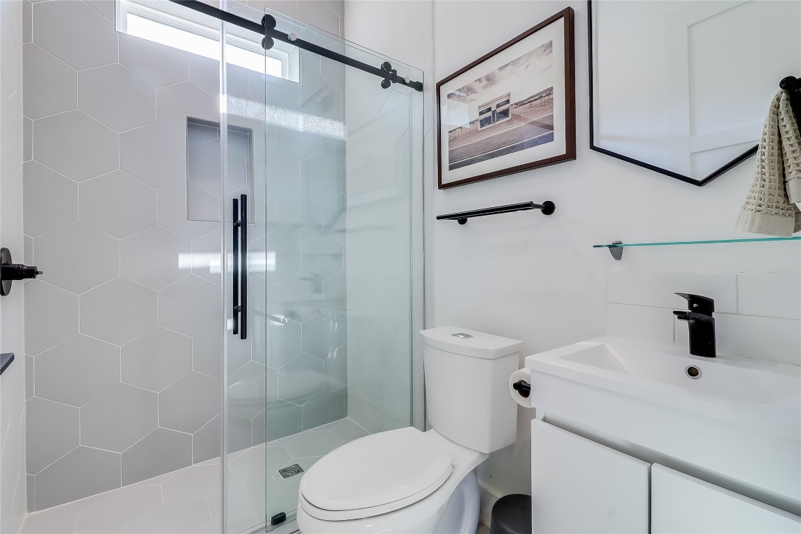 4712 Reyes Street, Unit 1 Austin, TX 78721 - Photo 16 of 40 a bathroom with a shower and a toilet