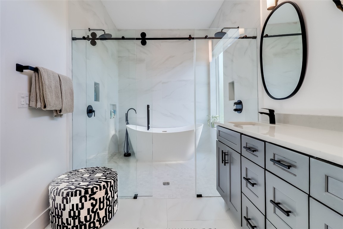 4712 Reyes Street, Unit 1 Austin, TX 78721 - Photo 22 of 40 a bathroom with a sink and a mirror