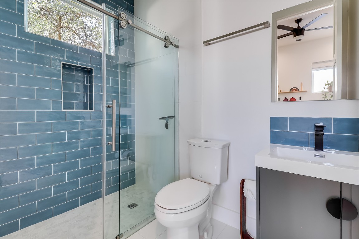 4712 Reyes Street, Unit 1 Austin, TX 78721 - Photo 26 of 40 a bathroom with a sink toilet and shower