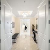 a view of a hallway with entryway windows and stairs