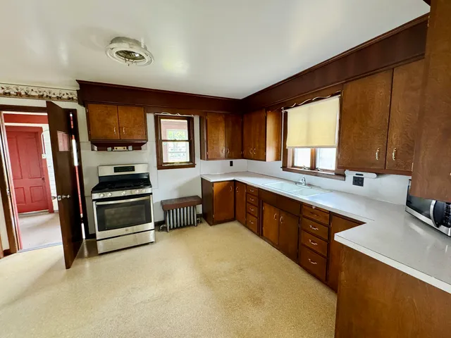 a kitchen with stainless steel appliances a stove sink and cabinets