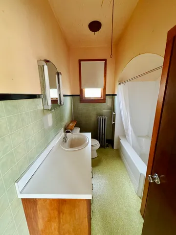 a bathroom with a sink a toilet and mirror