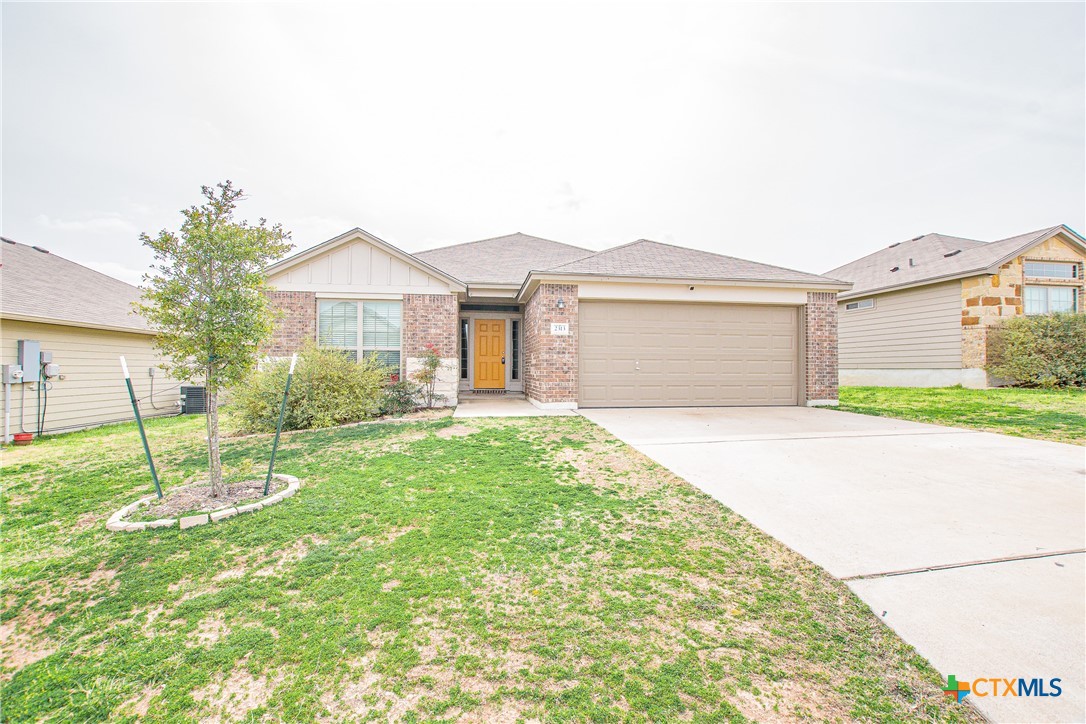 2313 Vicksburg Lane Temple, TX 76504 - Photo 1 of 1 a front view of a house with a yard and garage