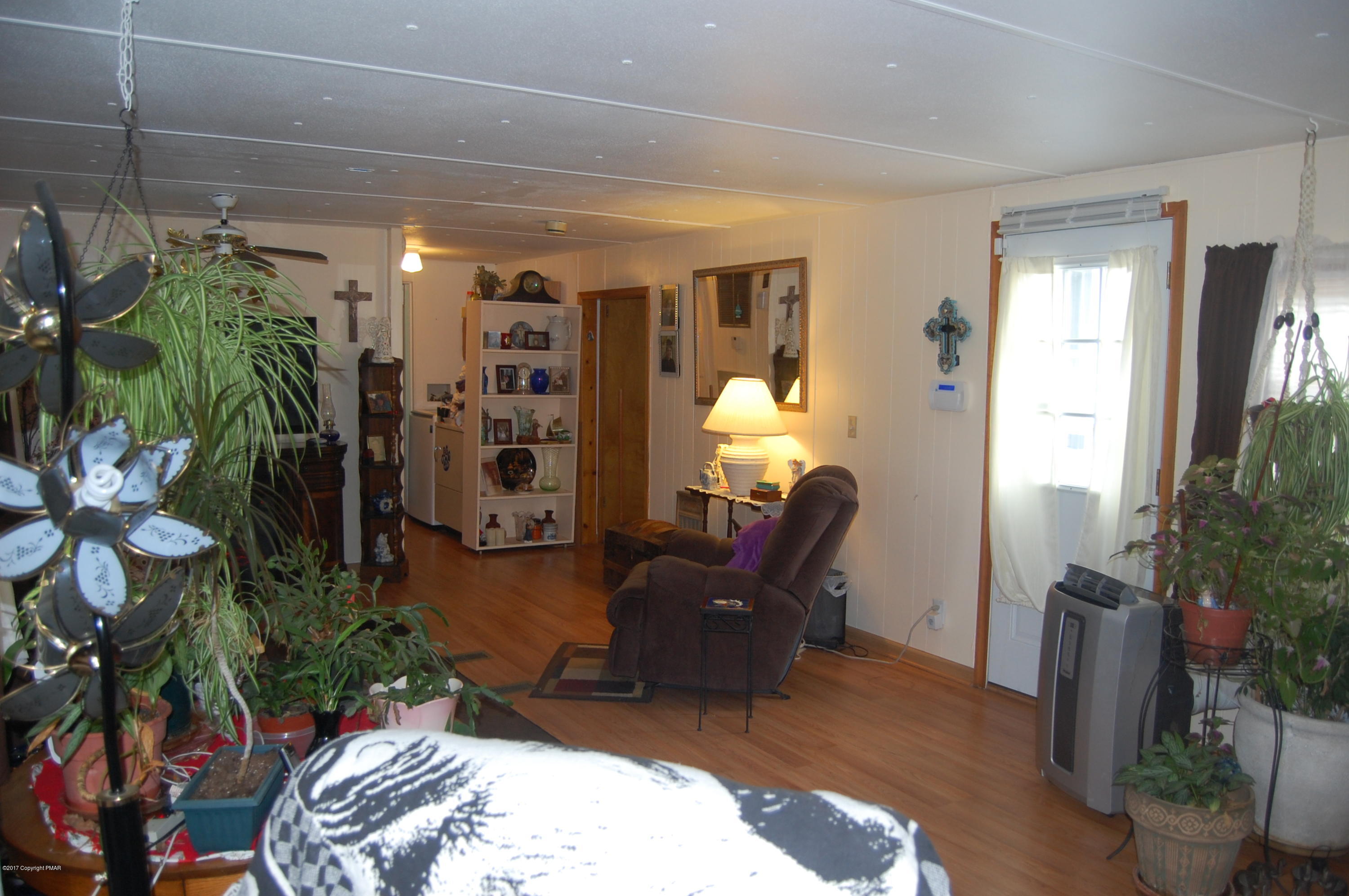 208 Clearview Road Long Pond, PA 18334 - Photo 8 of 35 a living room with furniture a potted plant and a large window
