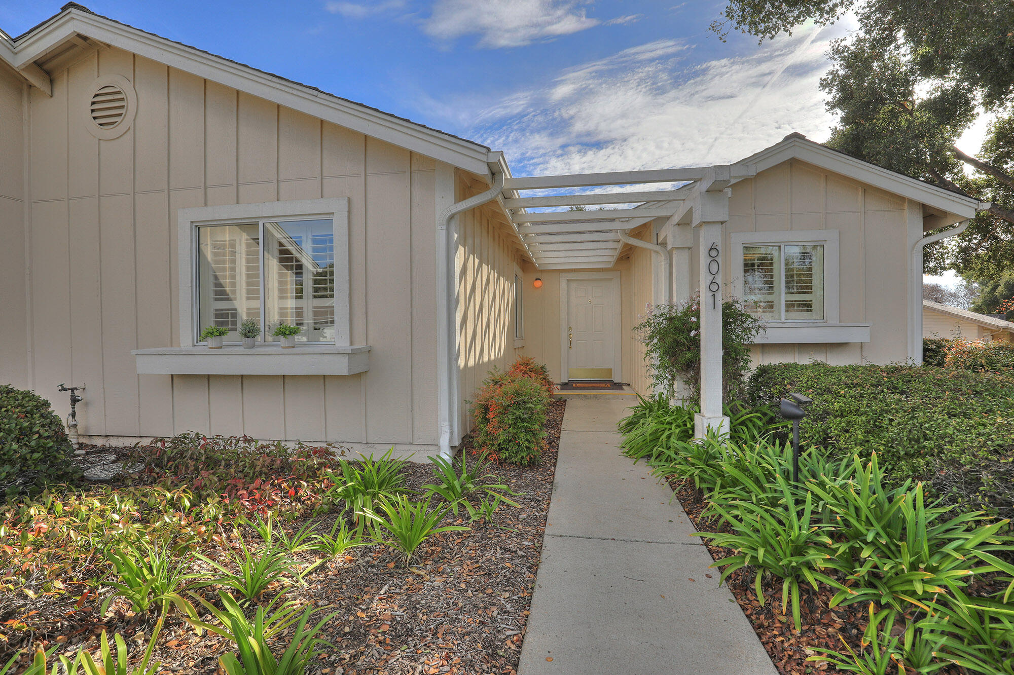 a front view of a house with garden