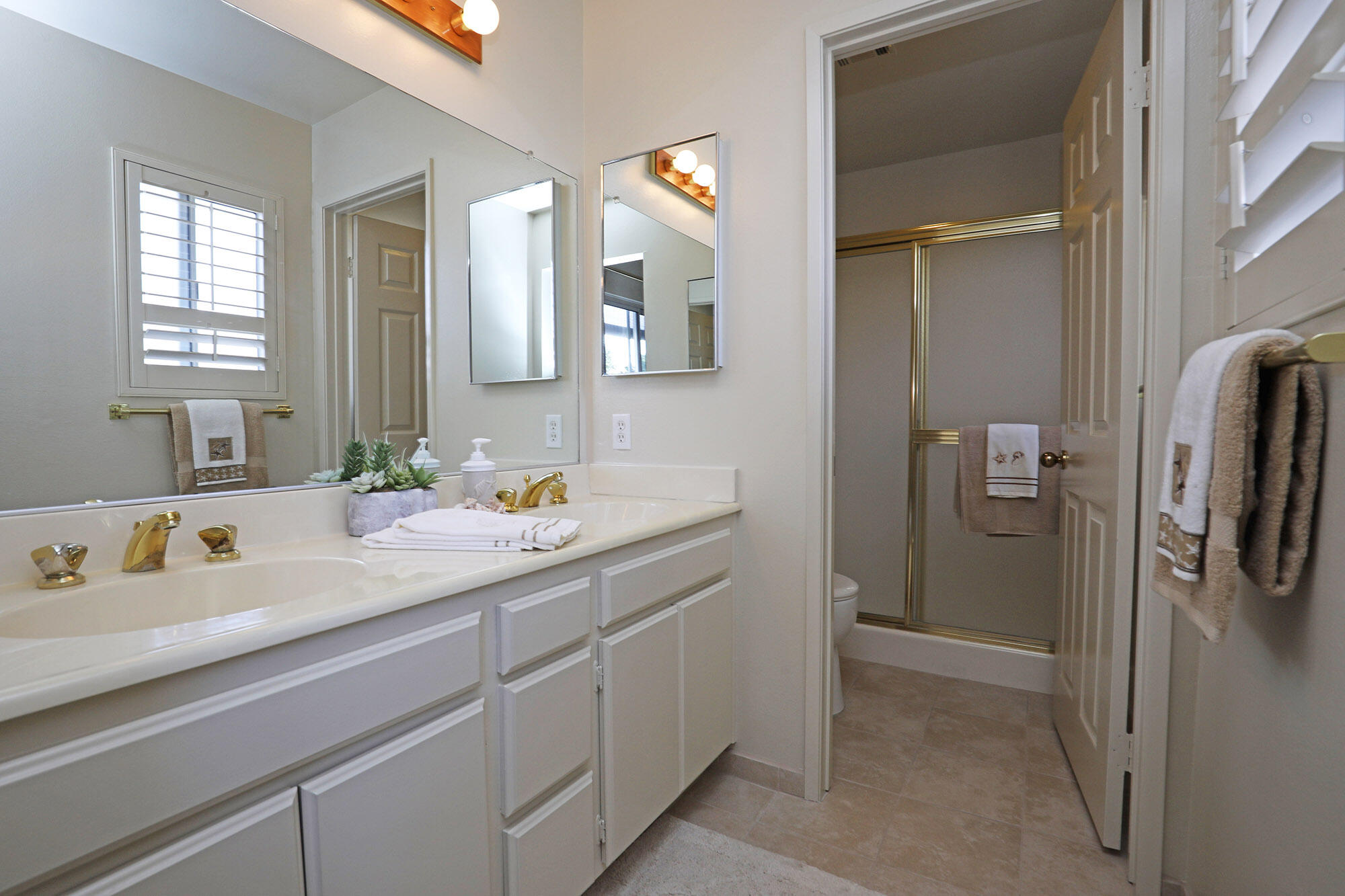 6061 Berkeley Road Goleta, CA 93117 - Photo 16 of 23 a en suite bathroom with a double vanity sink a mirror and a shower