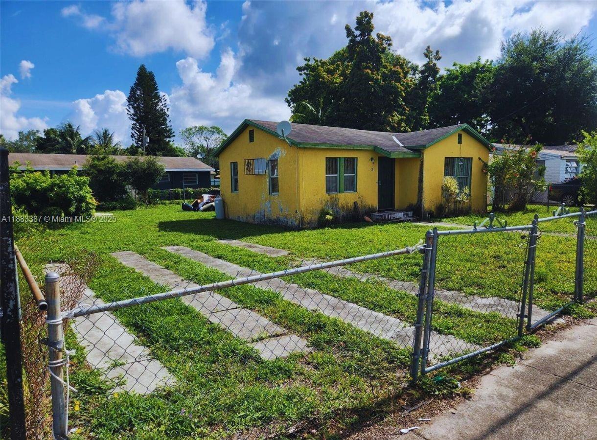2365 Northwest 79th Terrace Miami, FL 33147 - Photo 2 of 3 a front view of house with yard and green space