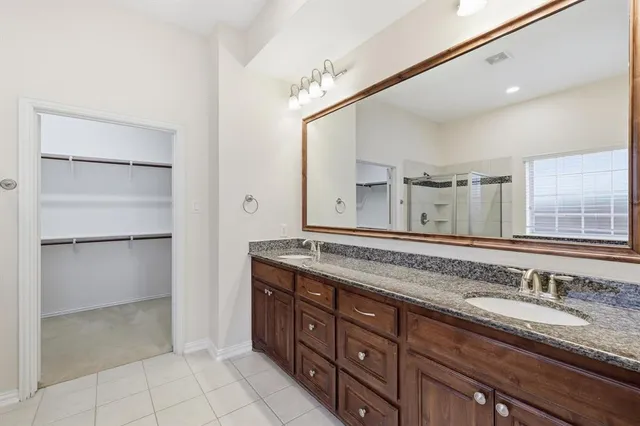 an empty room with windows and ceiling fan