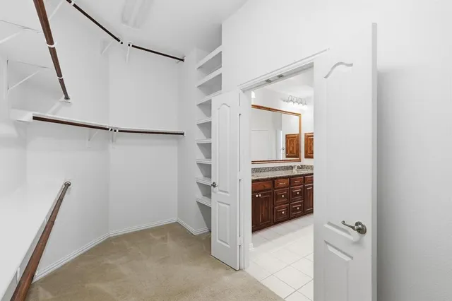 an empty room with a chandelier fan