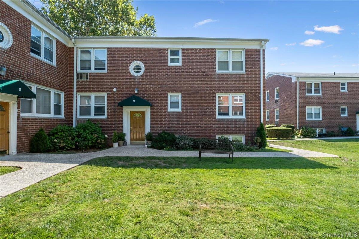 643 Pelham Road, Unit 9E New Rochelle, NY 10805 - Photo 1 of 1 a front view of a house with a yard