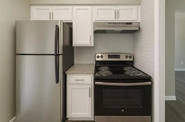 a kitchen with a stove and a refrigerator