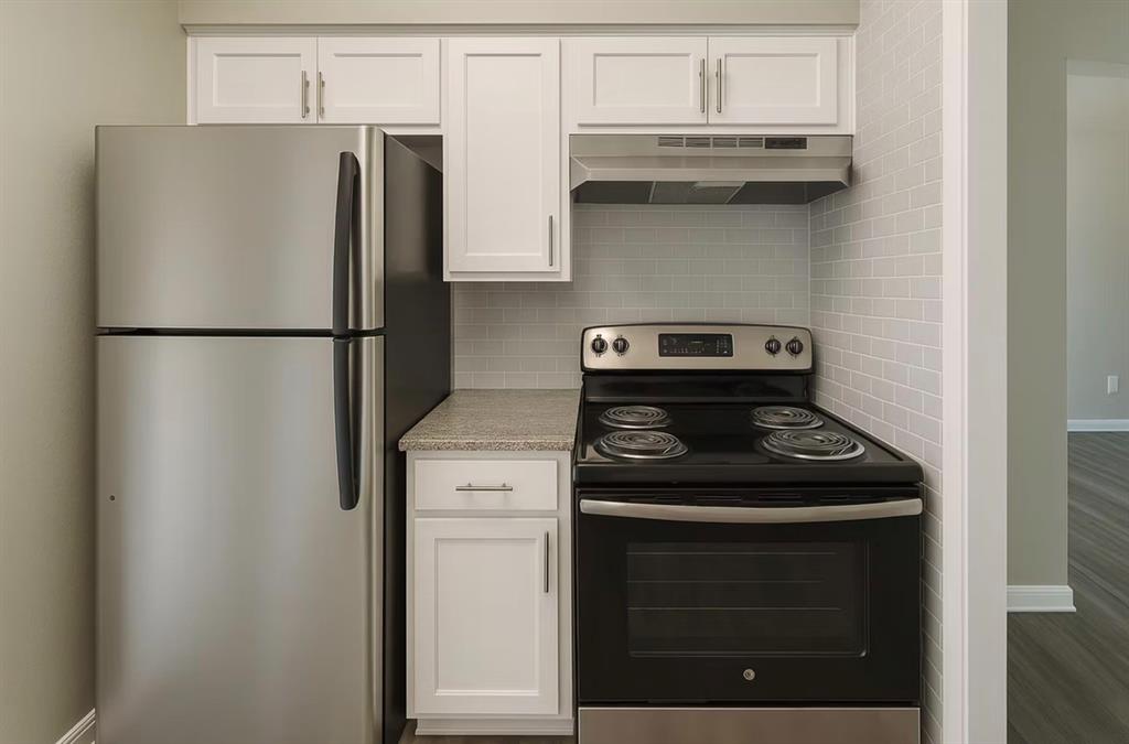 6151 East Mockingbird Lane Dallas, TX 75214 - Photo 3 of 8 a kitchen with a stove and a refrigerator