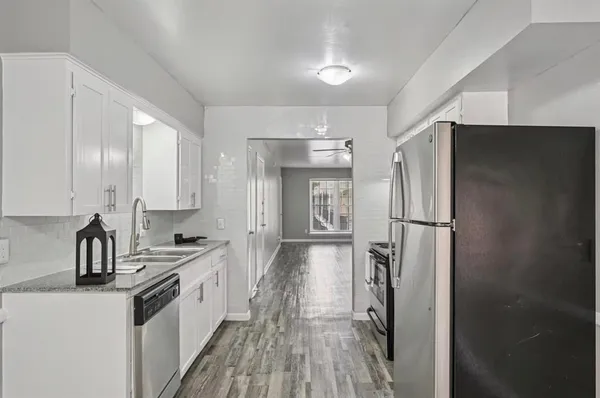 a kitchen with a refrigerator and a sink