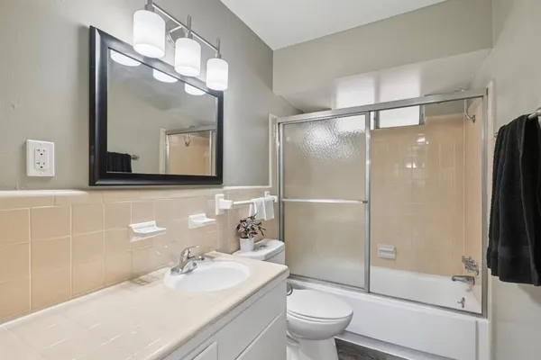 a bathroom with a sink toilet and shower