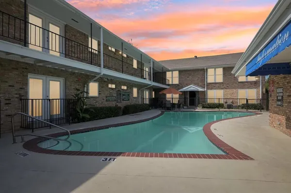 a view of a brick building with a yard